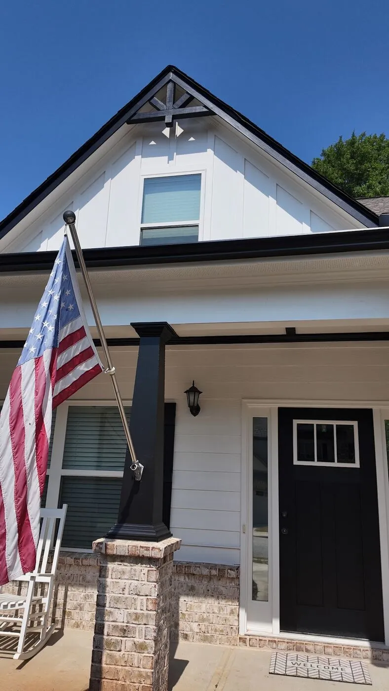 Front porch with black door and trim