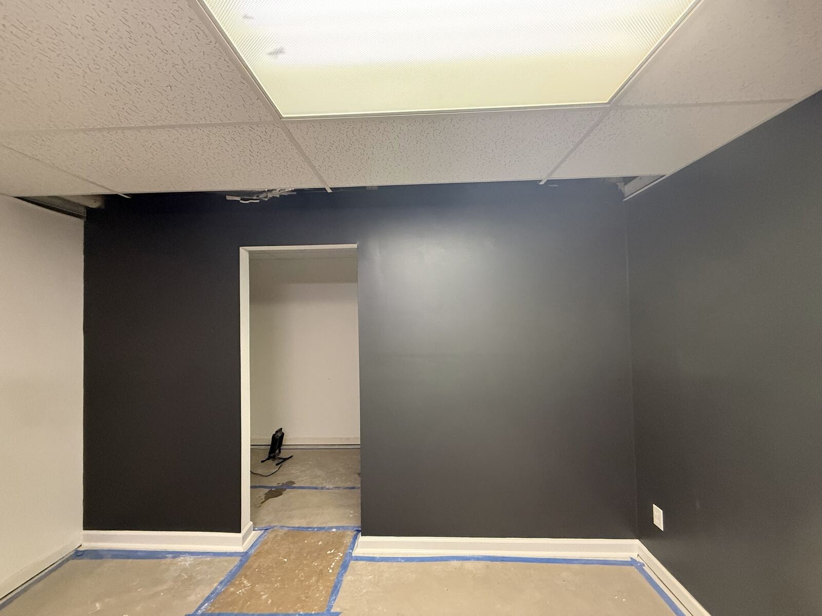 Room with a bold black accent wall
