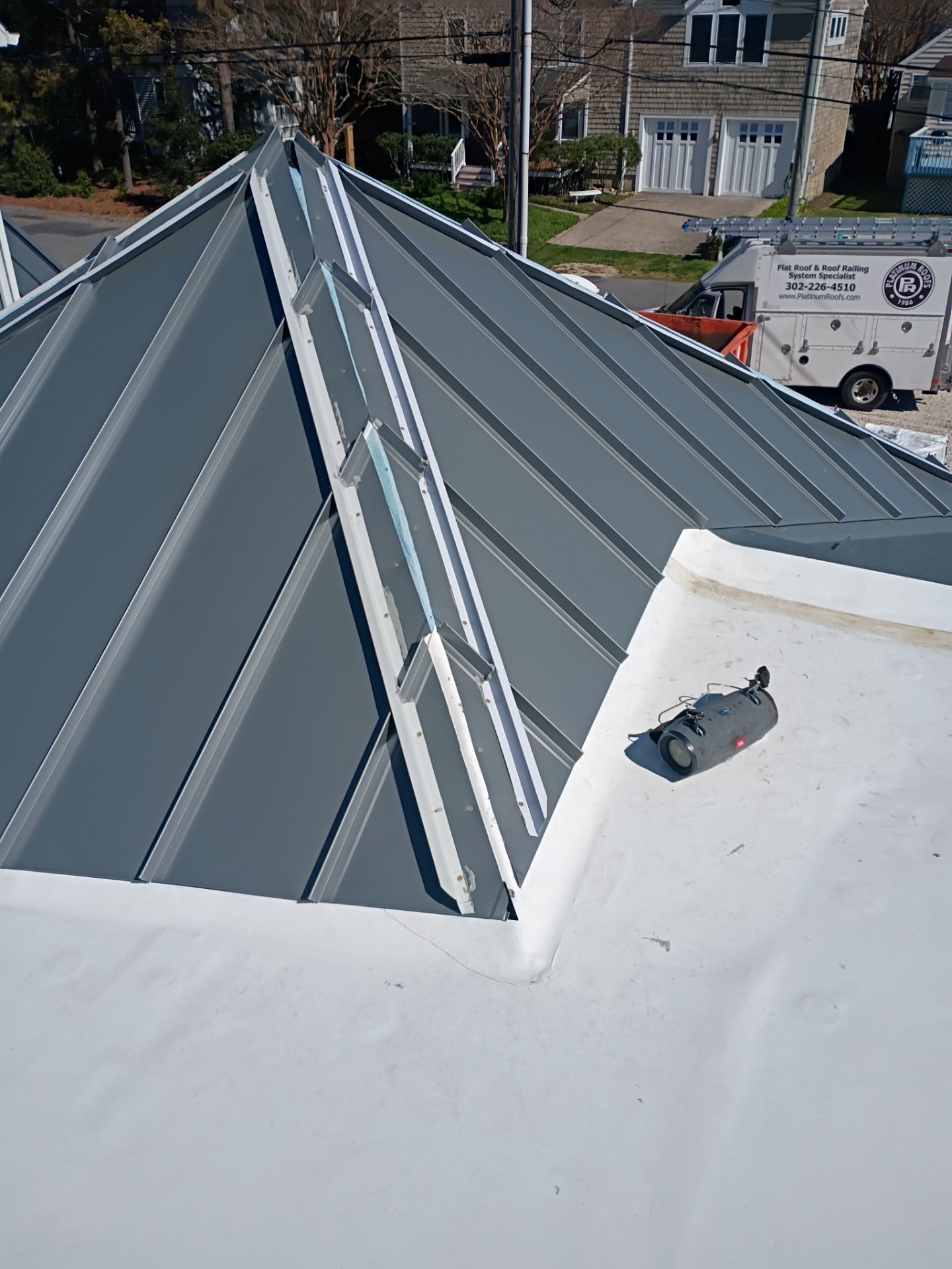 professional metal roof installation on residential property in Lewes Delaware, Platinum Roofs team installing durable roofing system designed for coastal weather conditions