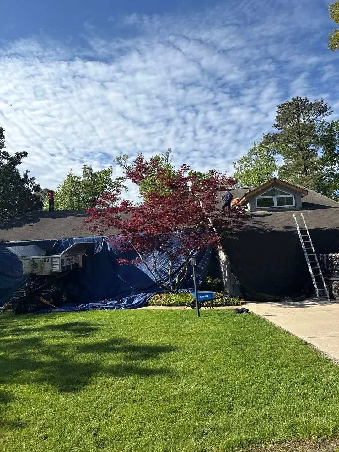 Roofing contractor repairing shingles after storm damage in Lewes Delaware