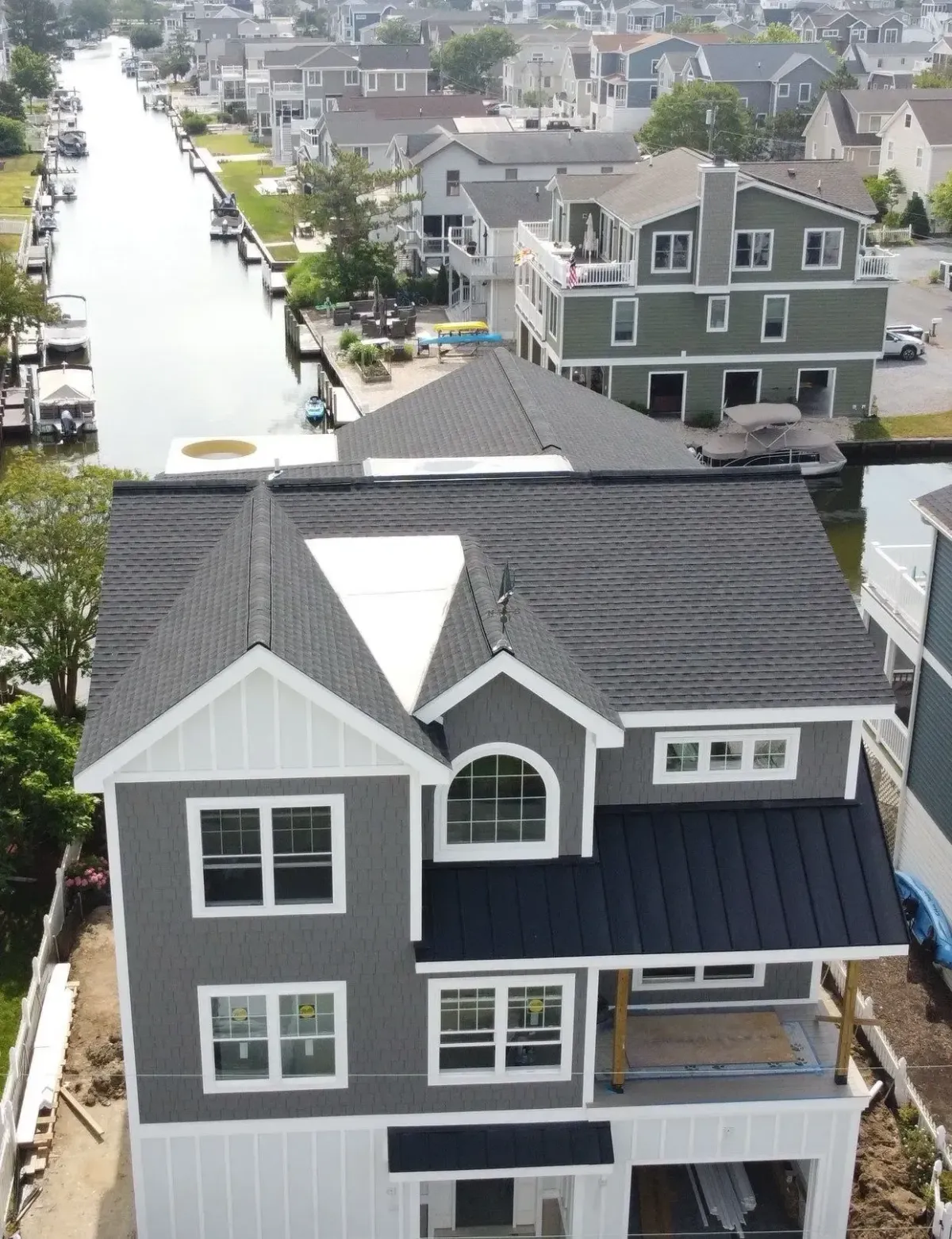 Platinum Roofs installing asphalt shingle roofing on new home along the Delaware canal