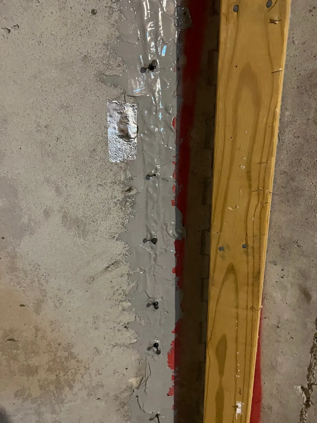 Close-up of a concrete foundation crack prepared for pressure injection