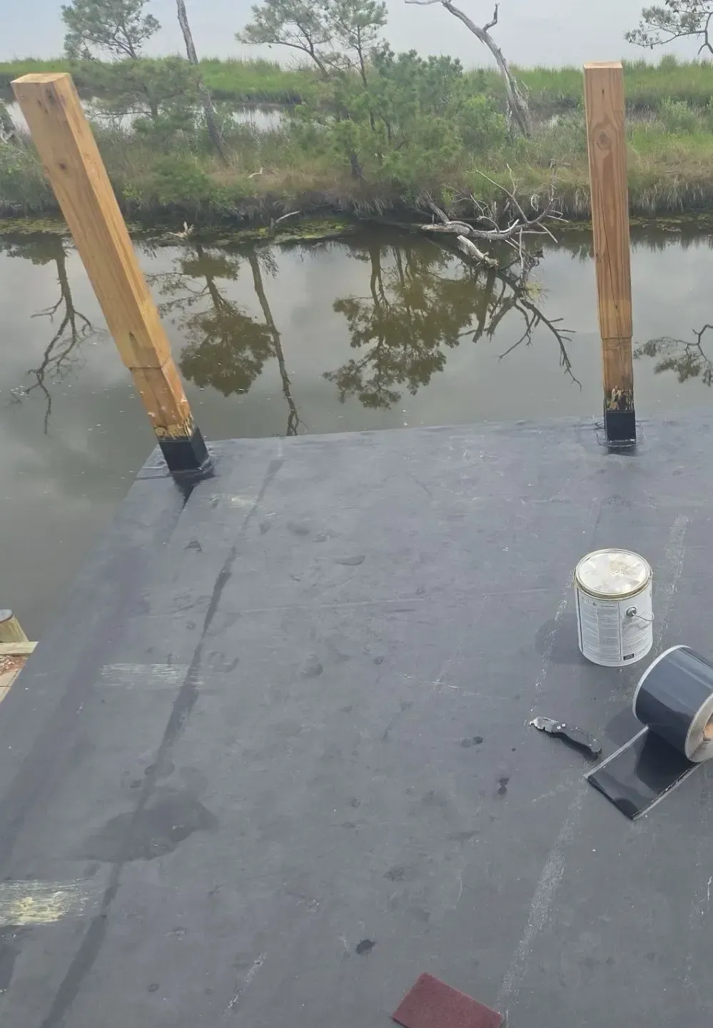Waterproof deck membrane and railing posts during installation on an elevated deck