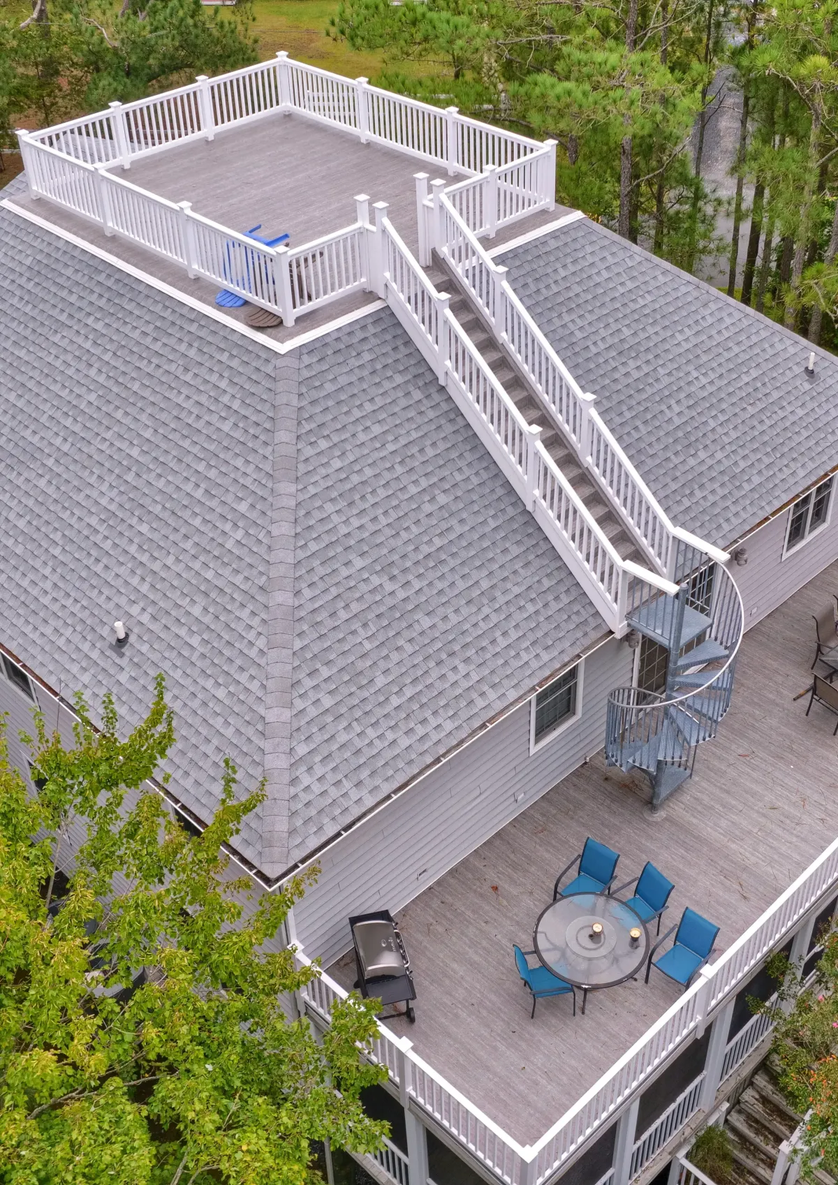 Aerial view of white PVC railings installed around an elevated rooftop deck