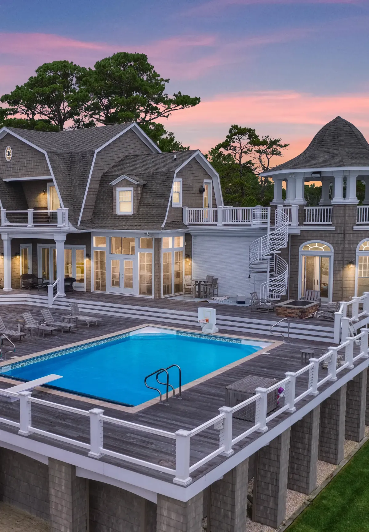 White PVC railing surrounding a pool deck at a coastal home