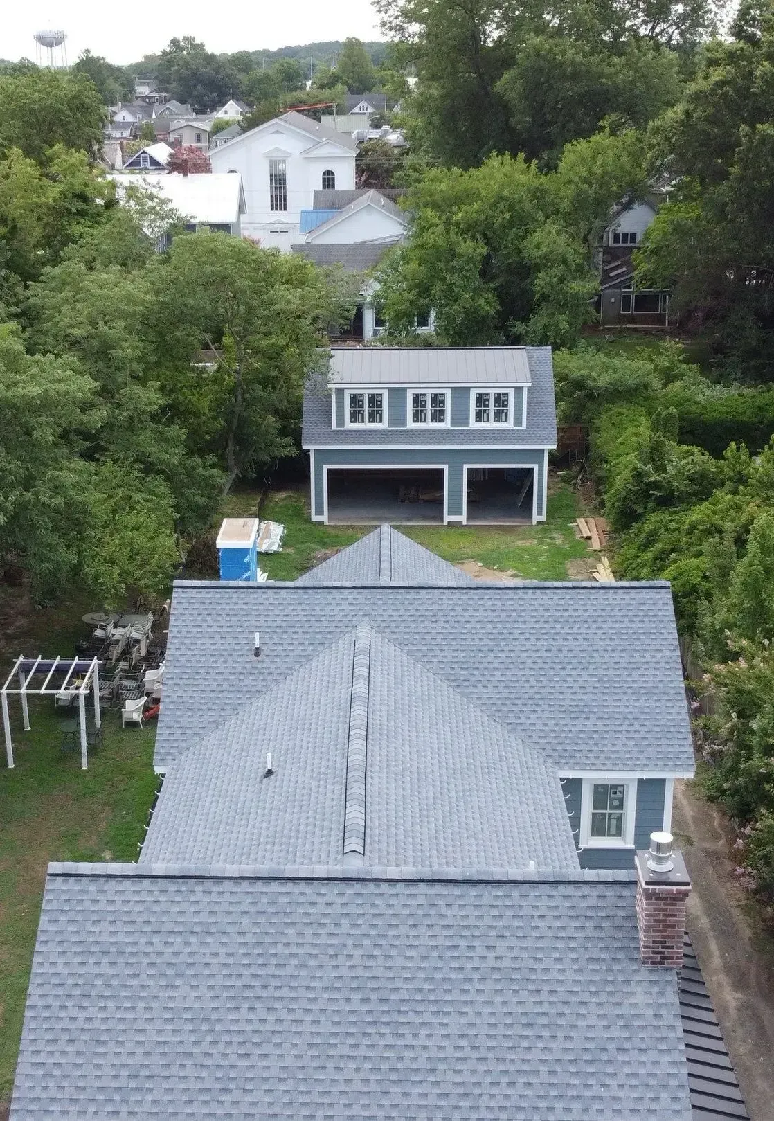 Aerial view of shingle roofs and homes in a tree-lined Lewes neighborhood