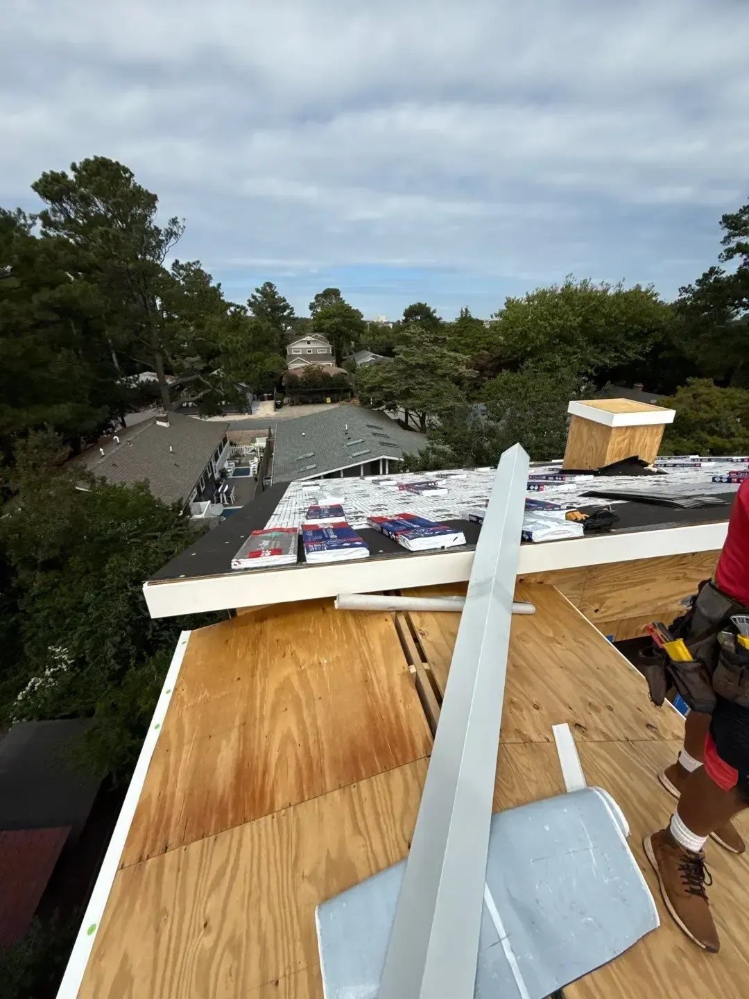 Roof installation in progress on a Dewey Beach property with new roof decking and metal edge details