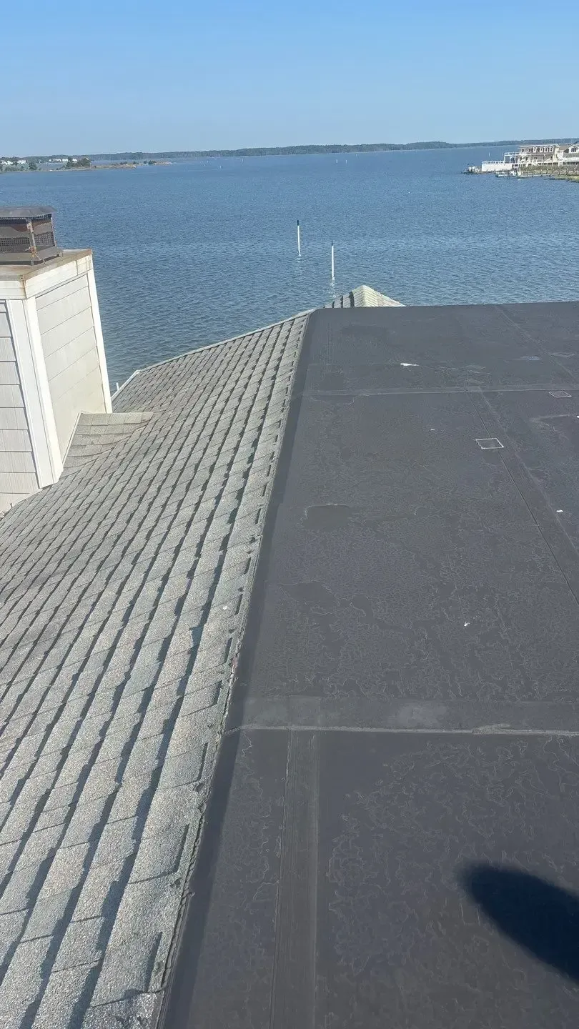Asphalt-shingle and flat roof at 51 Madison Avenue in Fenwick Island, Delaware, overlooking the bay.