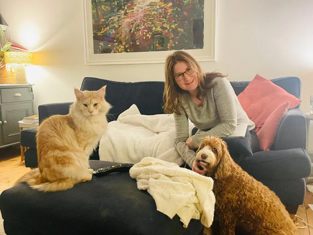Carrie Druce with her dog and cat, bringing grounded, heart-led support to spiritual and emotional healing
