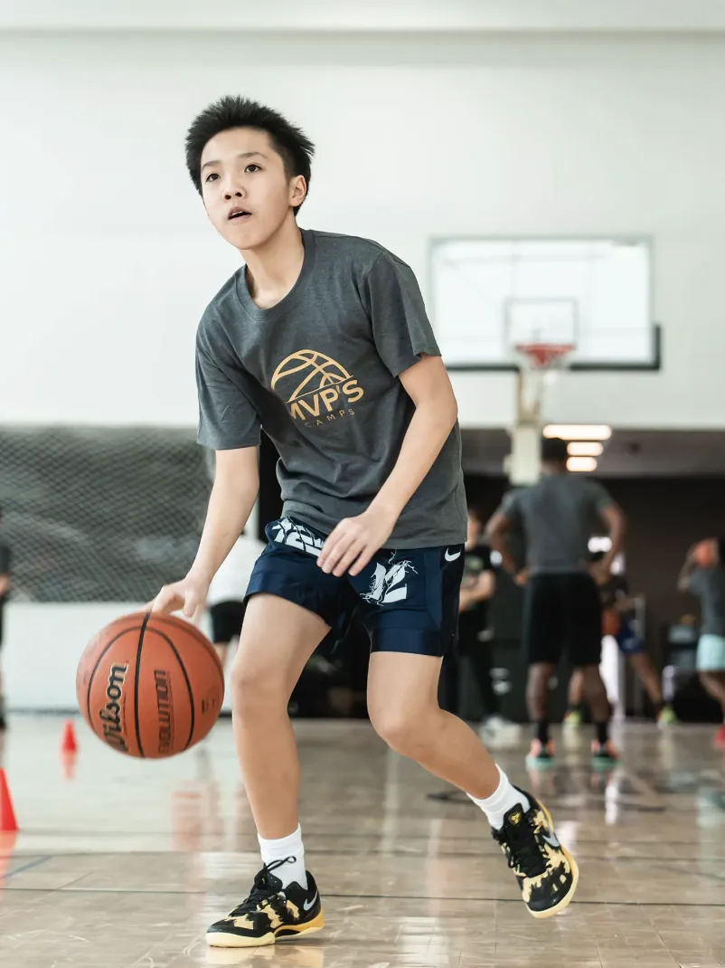 Basketball players mastering fast-break execution during competitive performance training