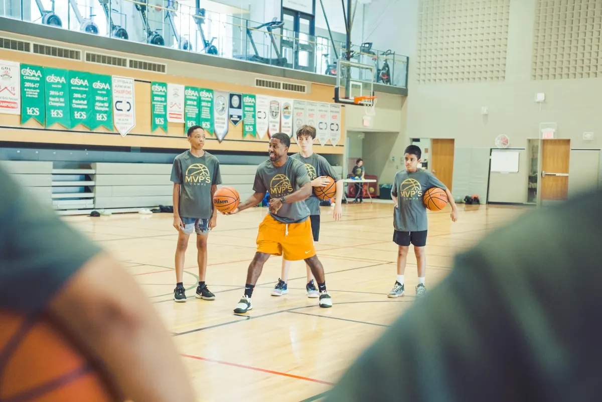 Basketball players enhancing agility and speed through elite performance drills  Elite youth athletes practicing game-winning shooting techniques during intensive training  High-level basketball development session focusing on advanced court movement and positioning
