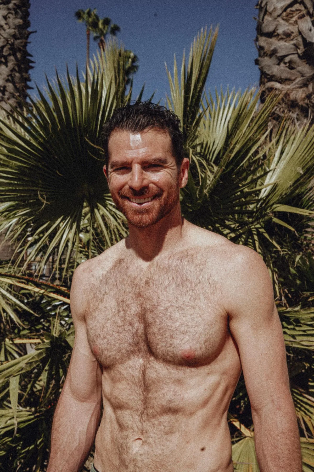 Jared Tavasolian, founder of Heal Strong, posing in front of trees