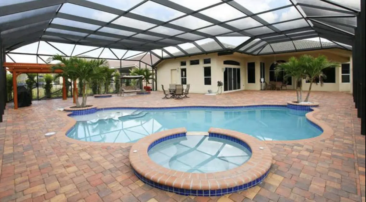An empty swimming pool with shadows on the ground
