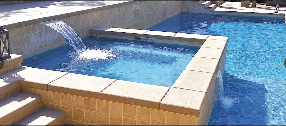 Red ladder leads into a swimming pool