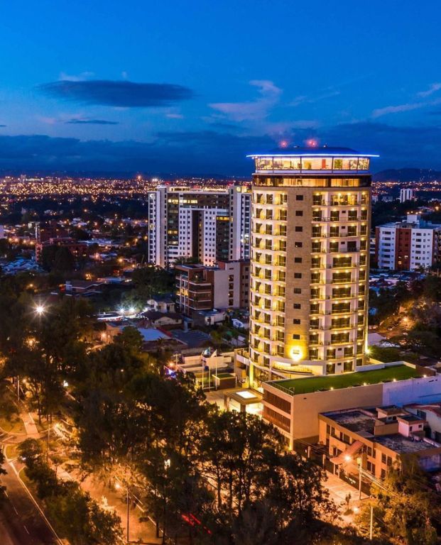 Aerial view of Oceana Resort in Guatemala featuring luxurious swimming pools, sun loungers, and palm trees, highlighting the serene setting for the Passover 2026 program.