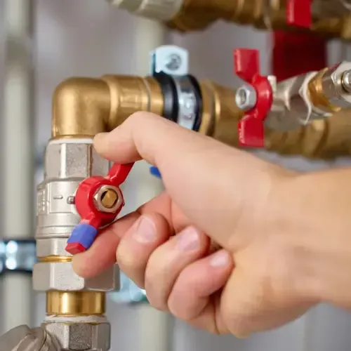 Professional plumber inspecting and repairing insulated ceiling pipes in a commercial building – Eddyson Plumbing offers expert pipe maintenance, leak detection, and industrial plumbing services.