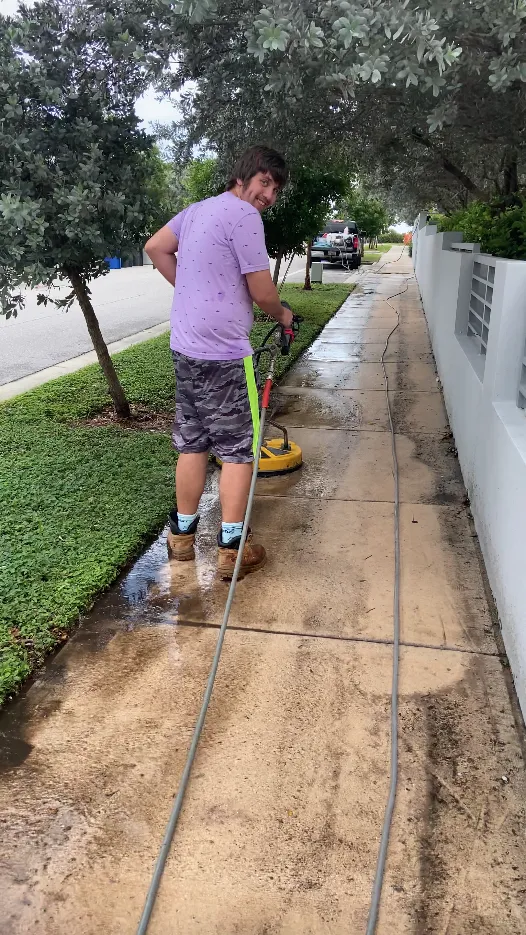 Pressure washing a sidewalk