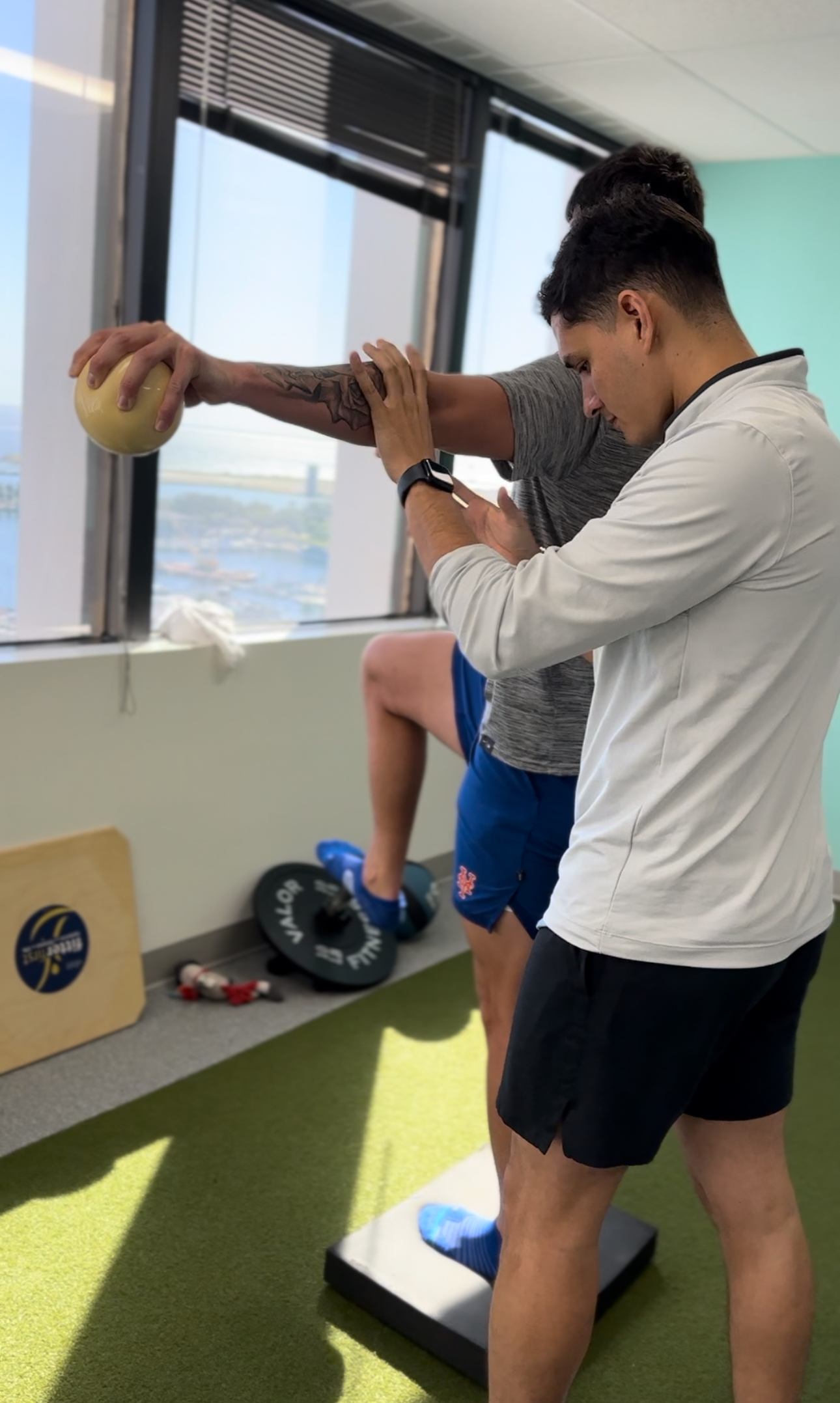 Physical therapist guiding a step-up exercise for knee pain rehabilitation at Alliance Regen & Rehab in downtown St. Petersburg, Florida.