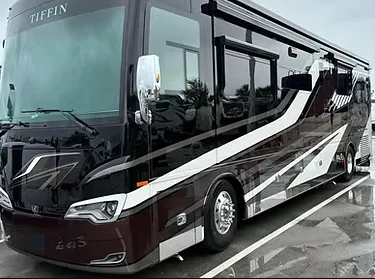 A family sedan with doors open, technicians cleaning both interior and exterior in a spotless service bay, with bright lighting highlighting the car’s renewed appearance and attention to detail.