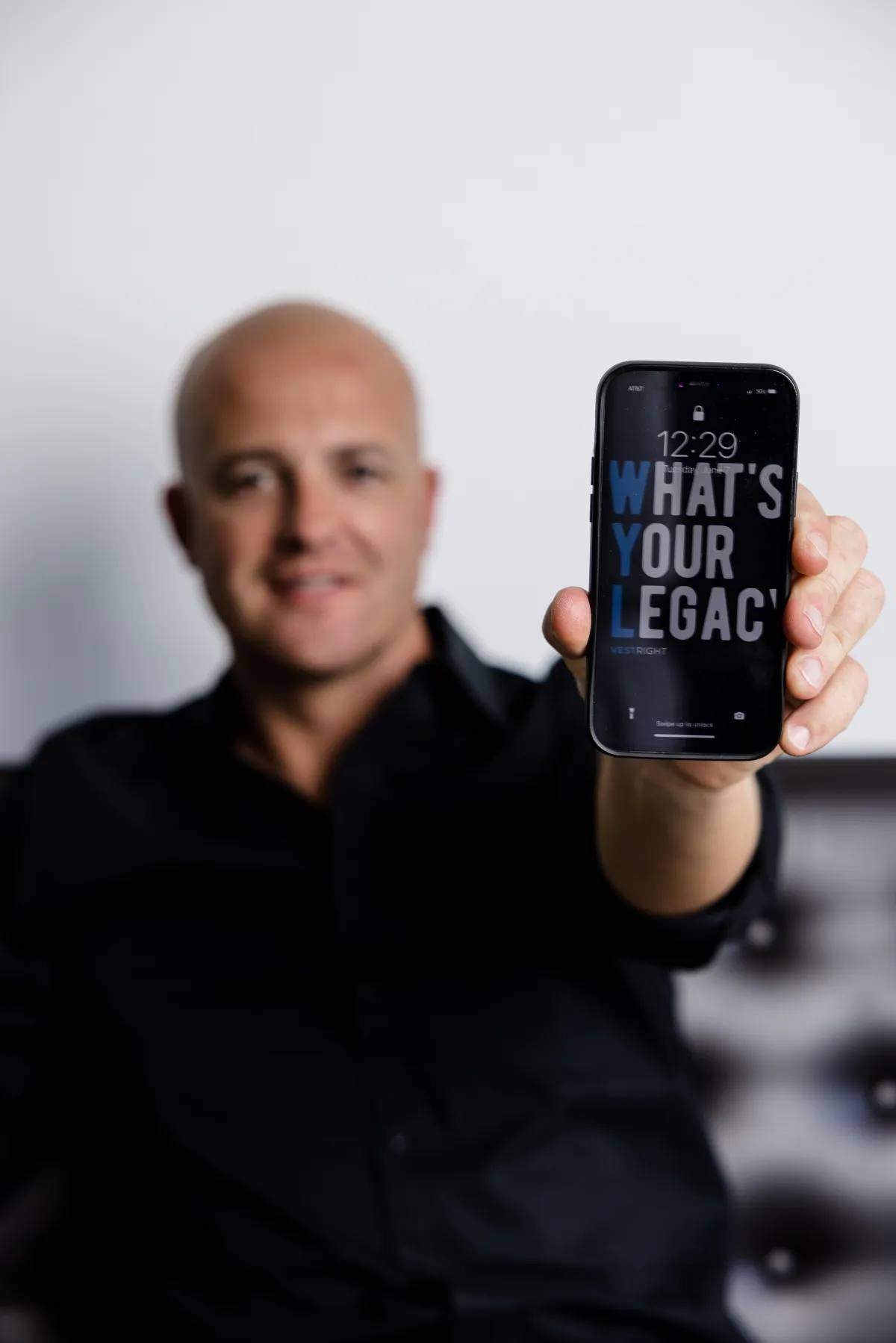 Cody Bjugan Holding Phone that says what's your legacy?