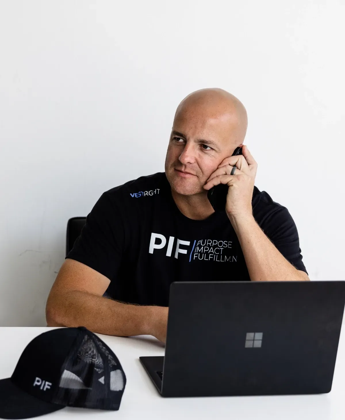 Cody Bjugan Contacting Clients On Cell Phone and Laptop
