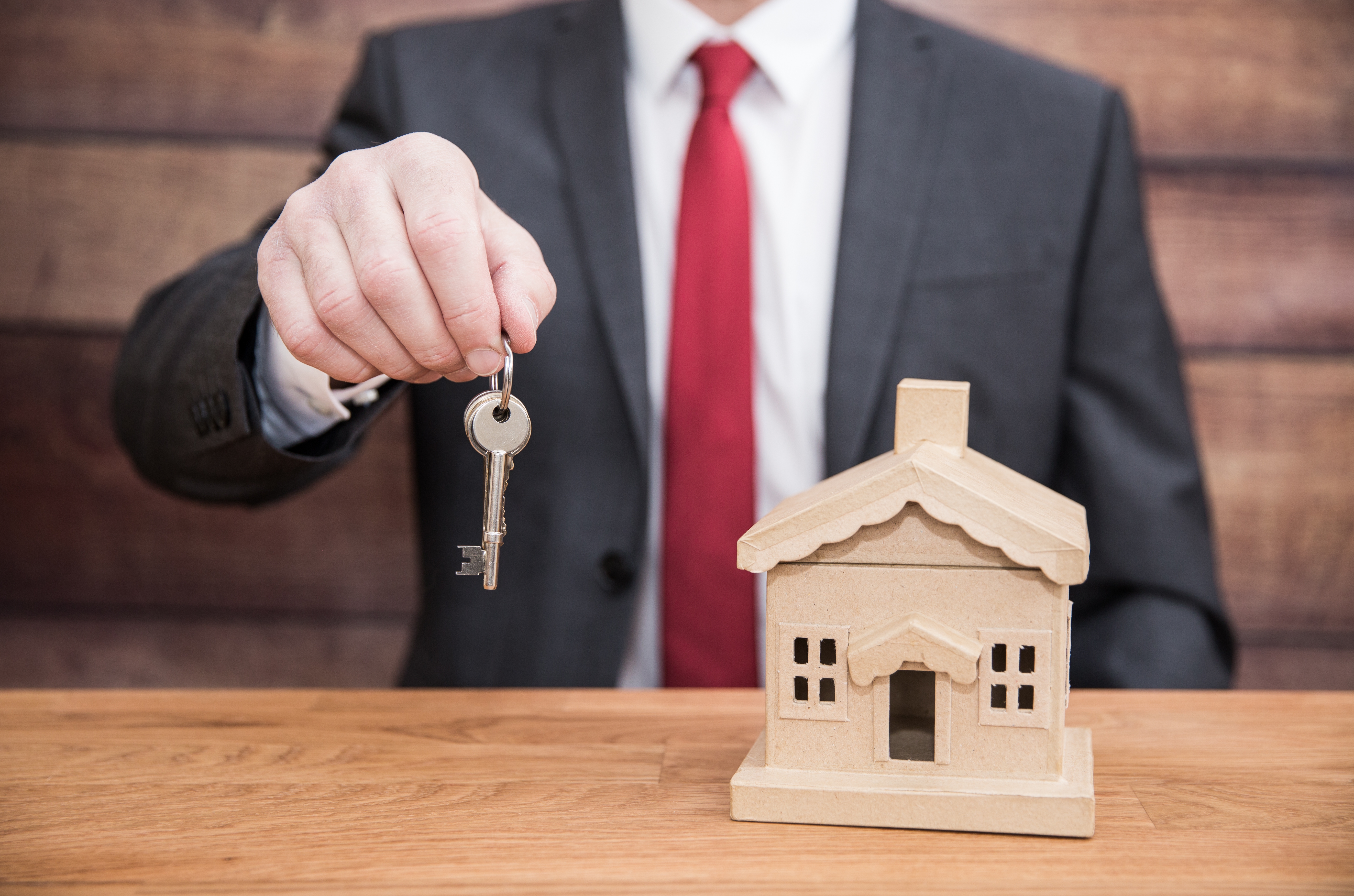 three men sitting on chair beside tables