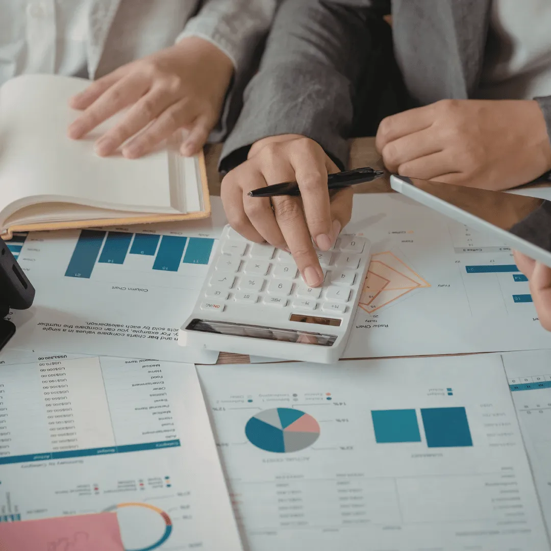 Financial planning with calculator, charts, and reports during budget and investment analysis.
