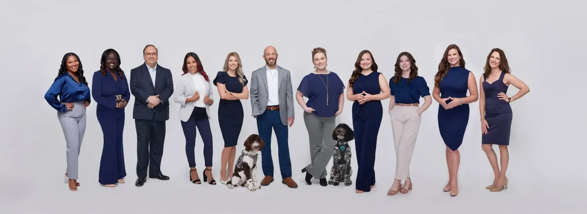 LumenWell care team of four diverse clinicians smiling in a bright, modern clinic lounge.