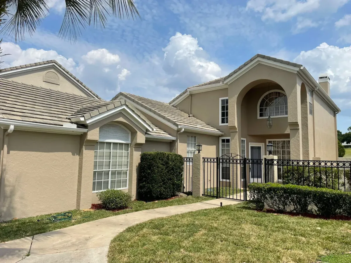 Side view of a luxury estate painted neutral colors by pro painting services.