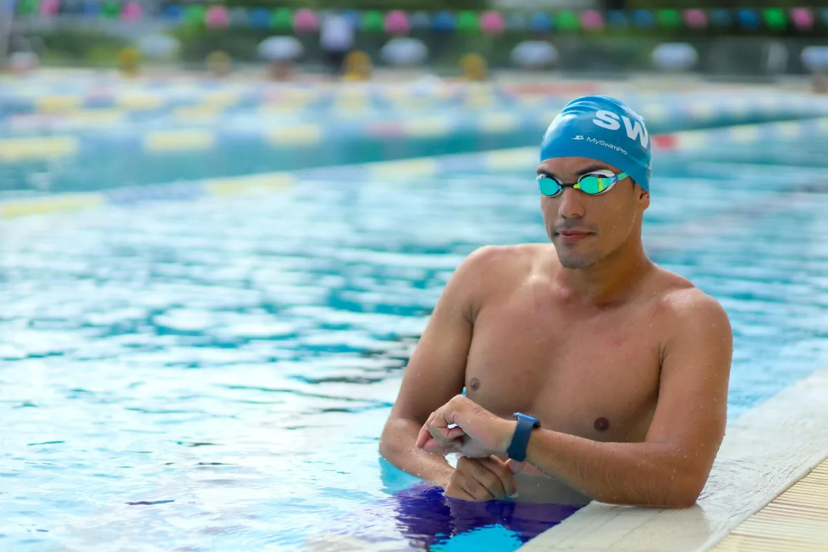 Child with arm floaties in shallow water