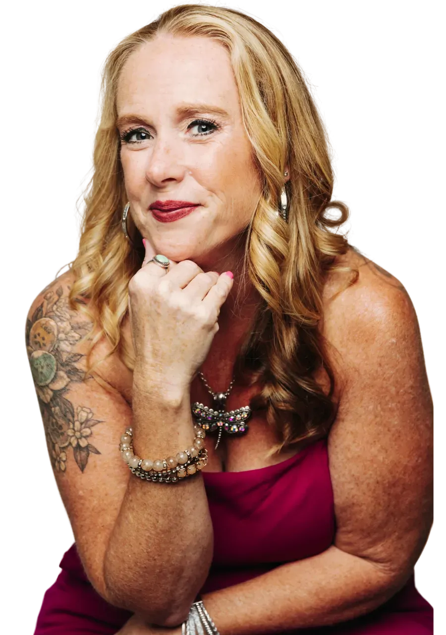Becca Powers® in a pink dress, chin resting on her hand, for the Expand With the AND email series