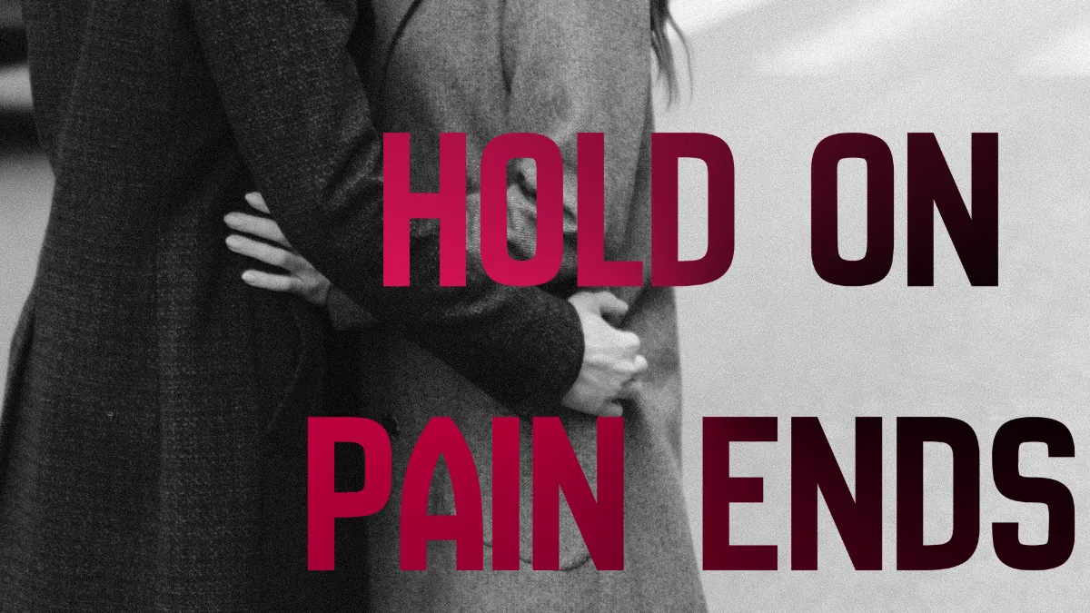 A couple in an emrace on a city street with overlay of Hold On Pain Ends written across