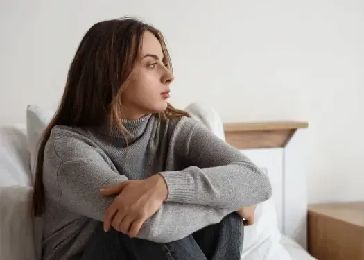 Vanessa Cardenas, Betrayal Recovery Specialist, helps others rebuild their lives after betrayal, with vibrant pink highlights representing hope and resilience. The image conveys a middle-aged couple's contemplation and the journey towards healing