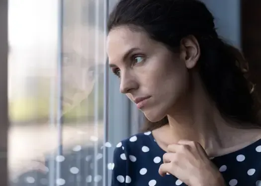 Woman reflecting on relationship decisions after betrayal while navigating opinions from family and friends