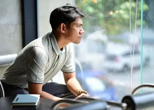 Man reflecting quietly after betrayal while processing questions about trust, self-worth, and relationship recovery