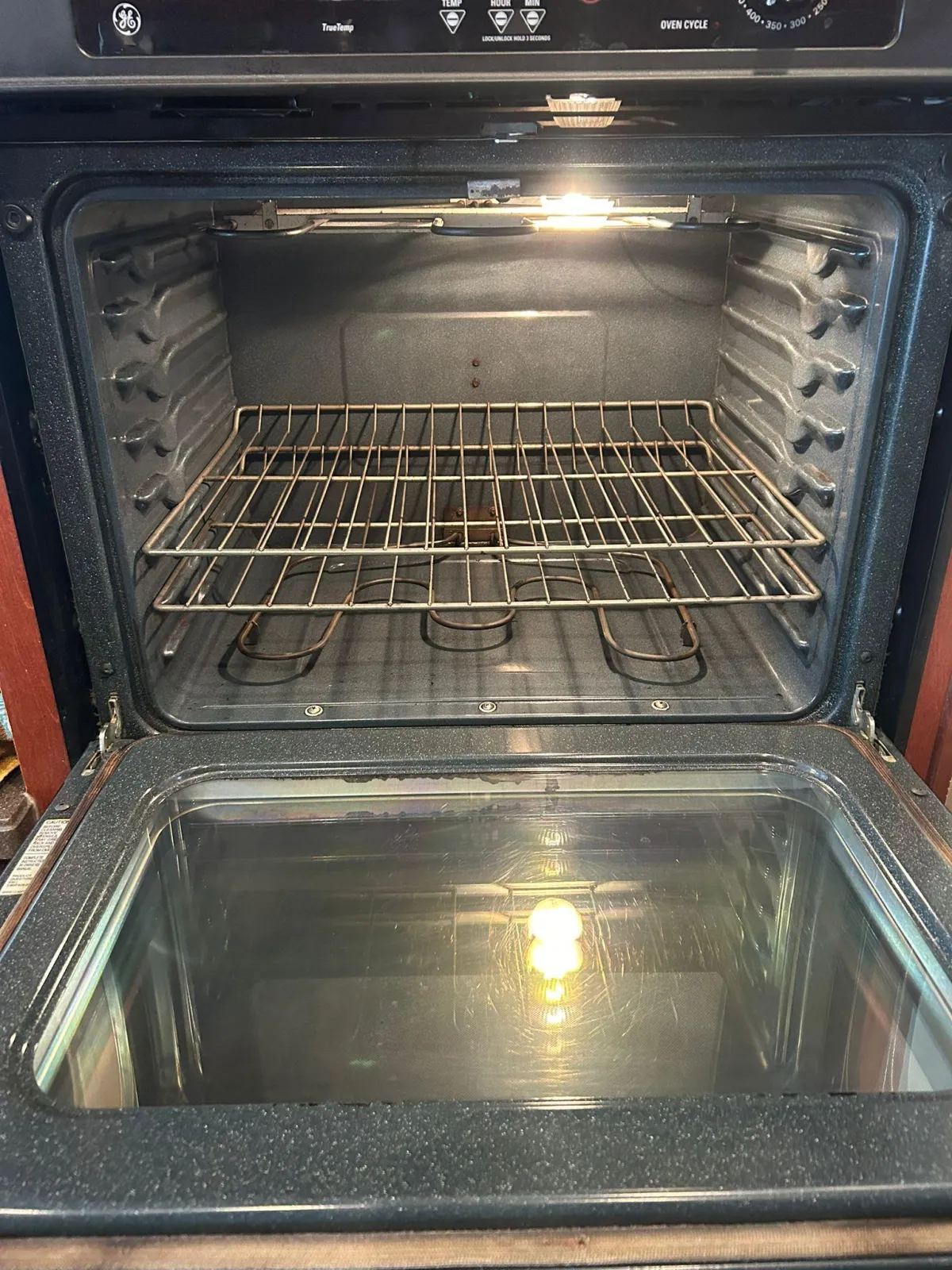 Inside view of an oven with a freshly cleaned interior, showing a spotless oven rack in Jacksonville.