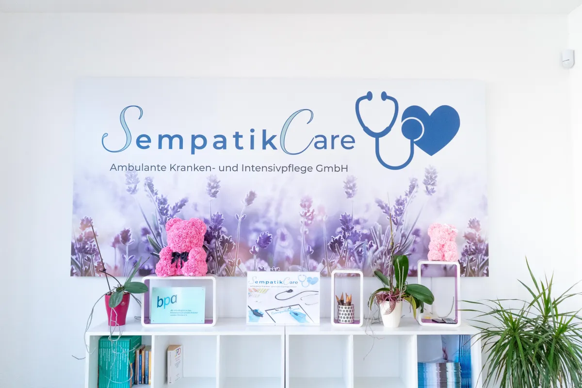 man in black and white jacket holding white and black cat