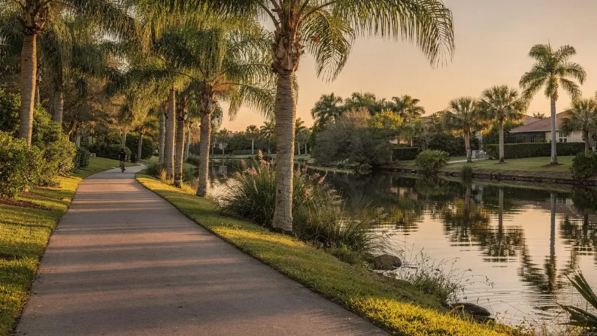 Bike path along a palm-lined canal in Port St. Lucie at golden hour