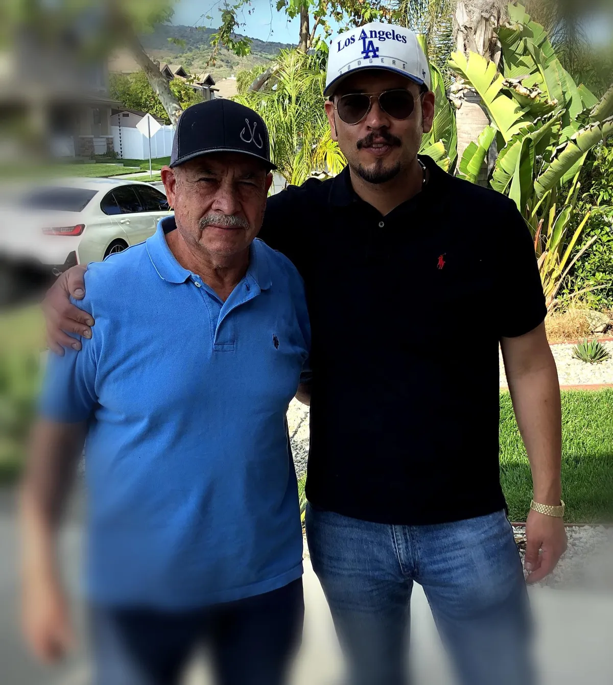 Owner and his father in professional plumbing uniform holding heavy-duty tools