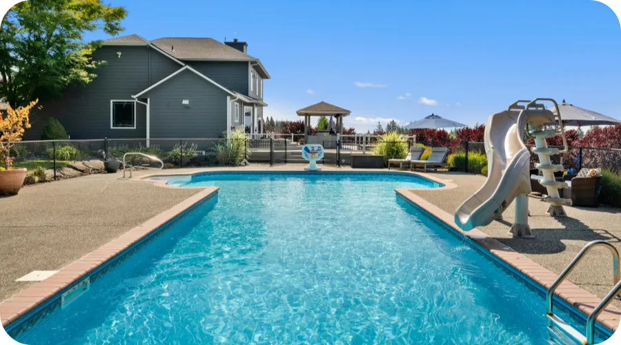 Backyard swimming pool with slide inspected during a pool inspection in Wilmington, DE.