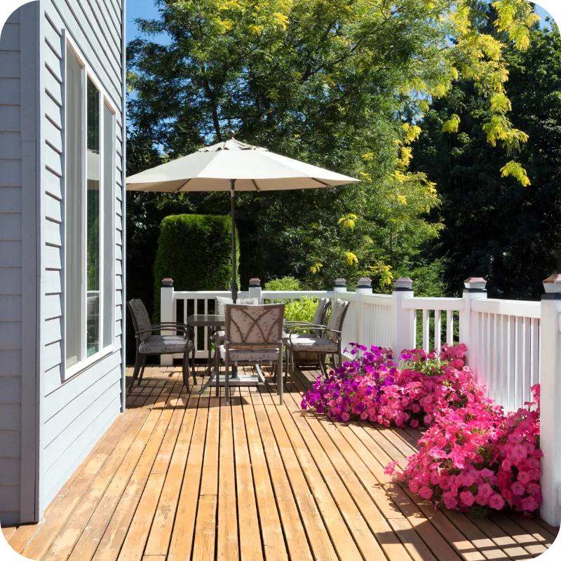 Wooden deck with patio furniture and flowers inspected during a home inspection in Wilmington, DE.