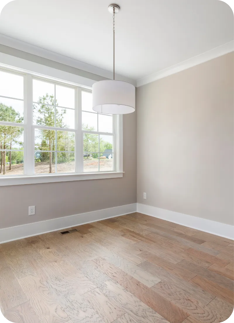 Bright room in Delaware with wooden floors and beige walls, ideal for home inspection of flooring and wall conditions.