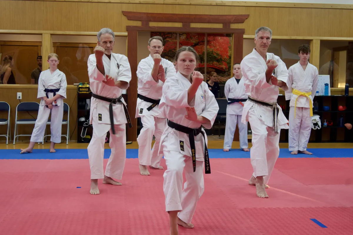 a group of young evacuees receiving instruction in Jiu Jitsui, or Judo wrestling at Portland (Oregon) Assembly Center, while the rest of class look on