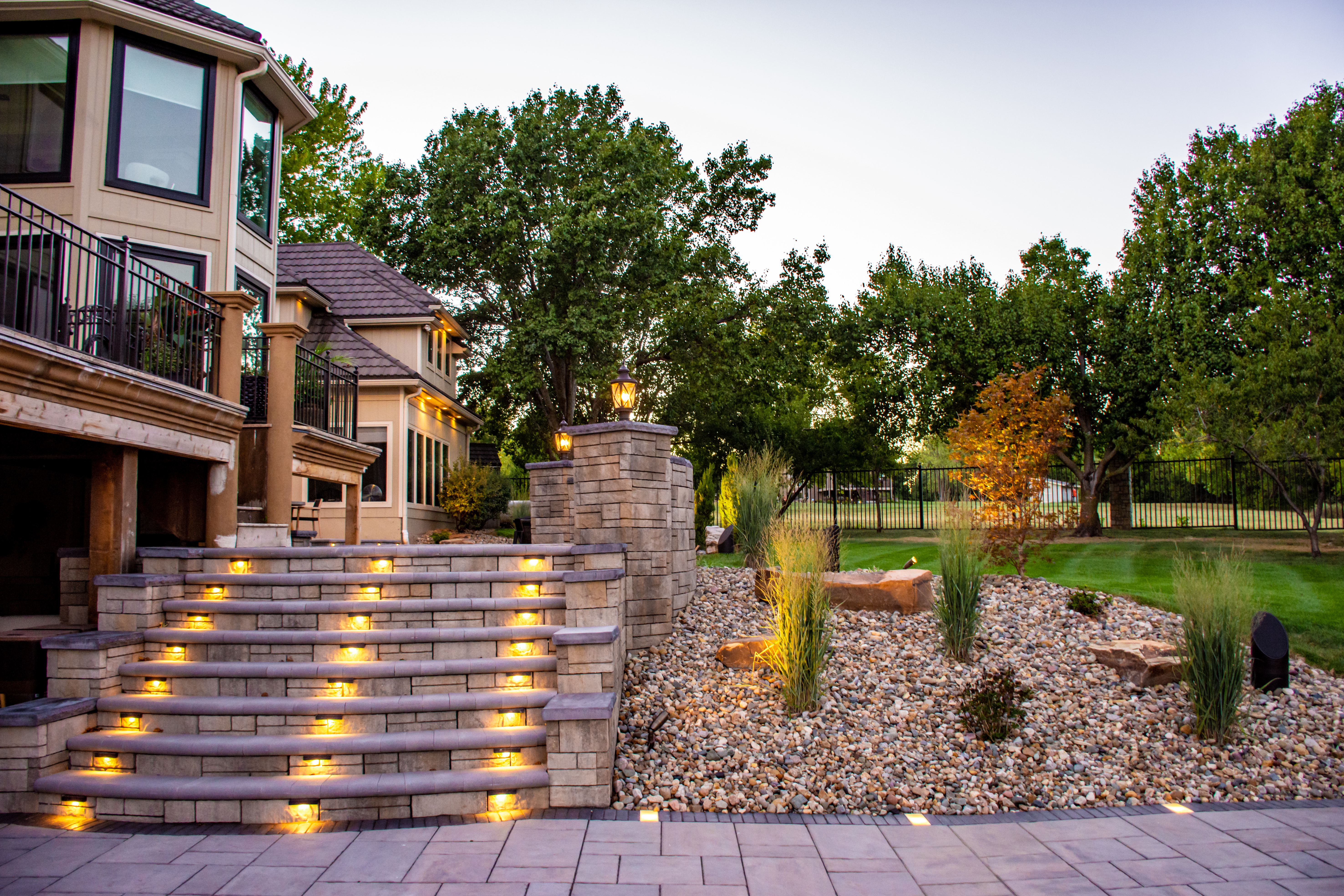 a pathway in a park with trees and bushes
