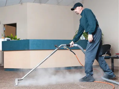 Man Cleaning carpet with steam
