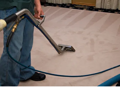 Man Cleaning Carpet with a Carpet cleaning wand