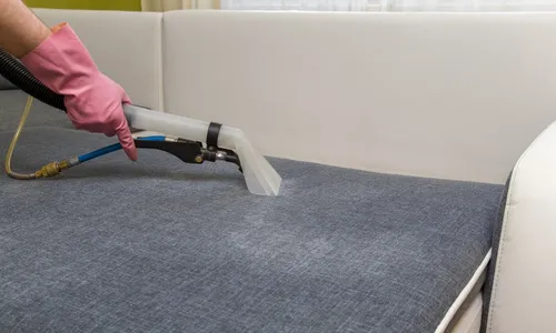 Diverse group of volunteers holding trash bags by water