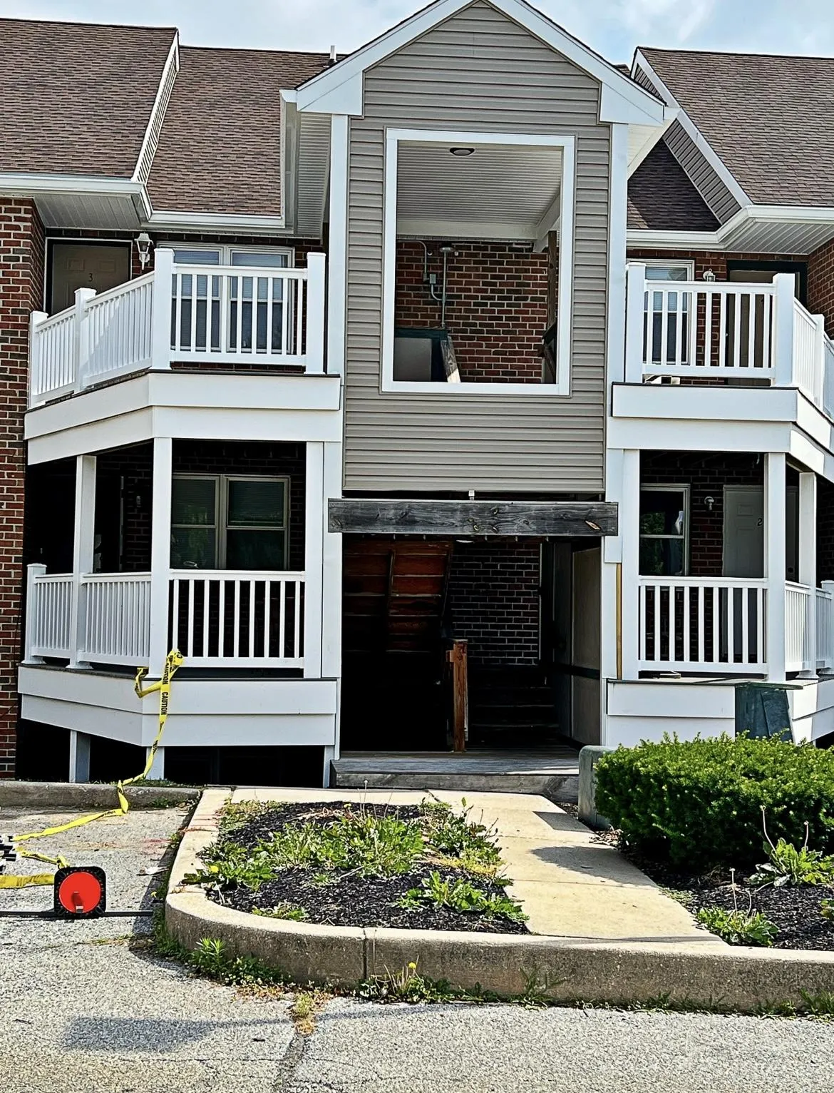 Two-story townhome with stacked white-railing decks and porches | Prime Decks Delaware, serving Newark, DE