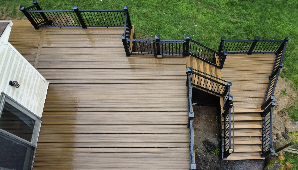 Top-down view of a tan composite deck with black railings and a corner staircase | Prime Decks Delaware, serving Greenville, DE