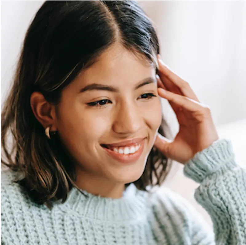 smiling woman wearing a blue sweater